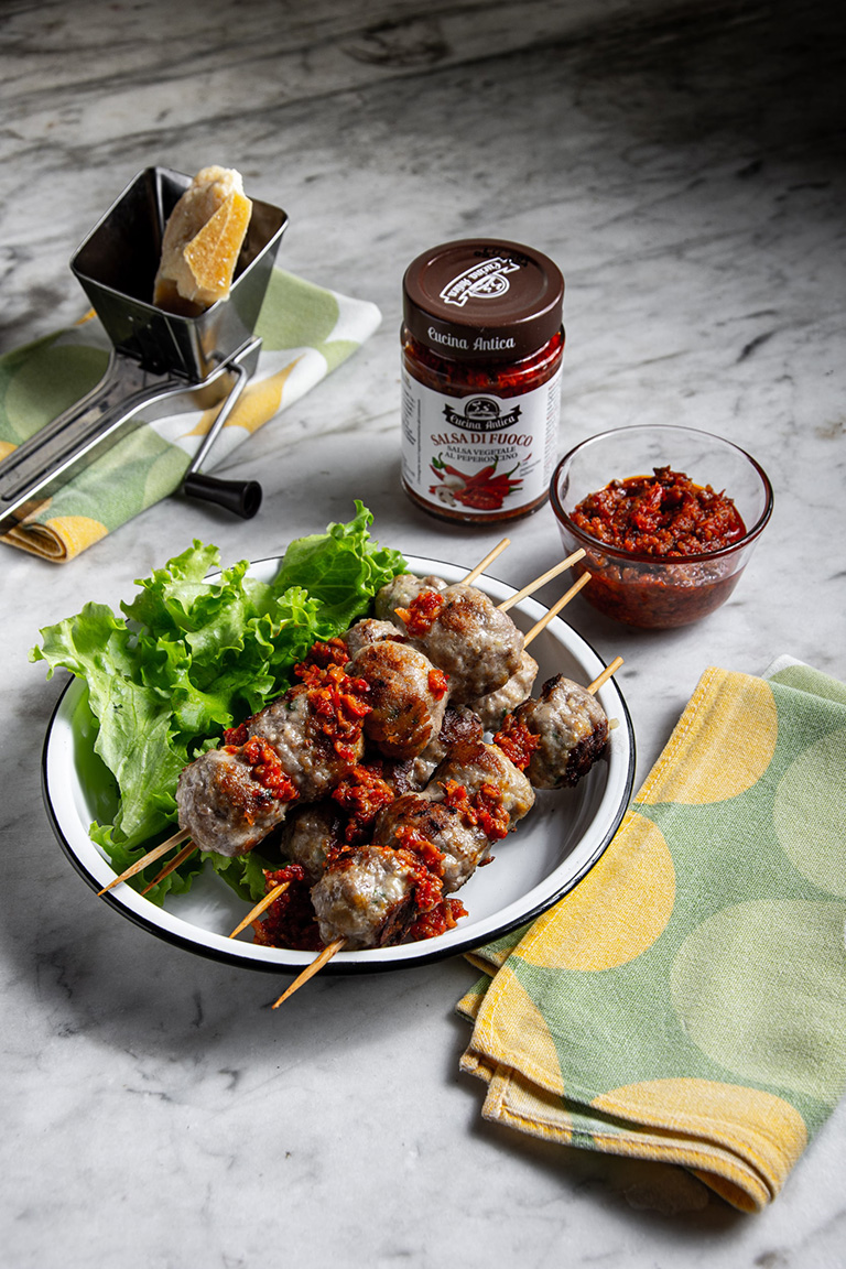 Meatball skewers with hot chilli pepper sauce